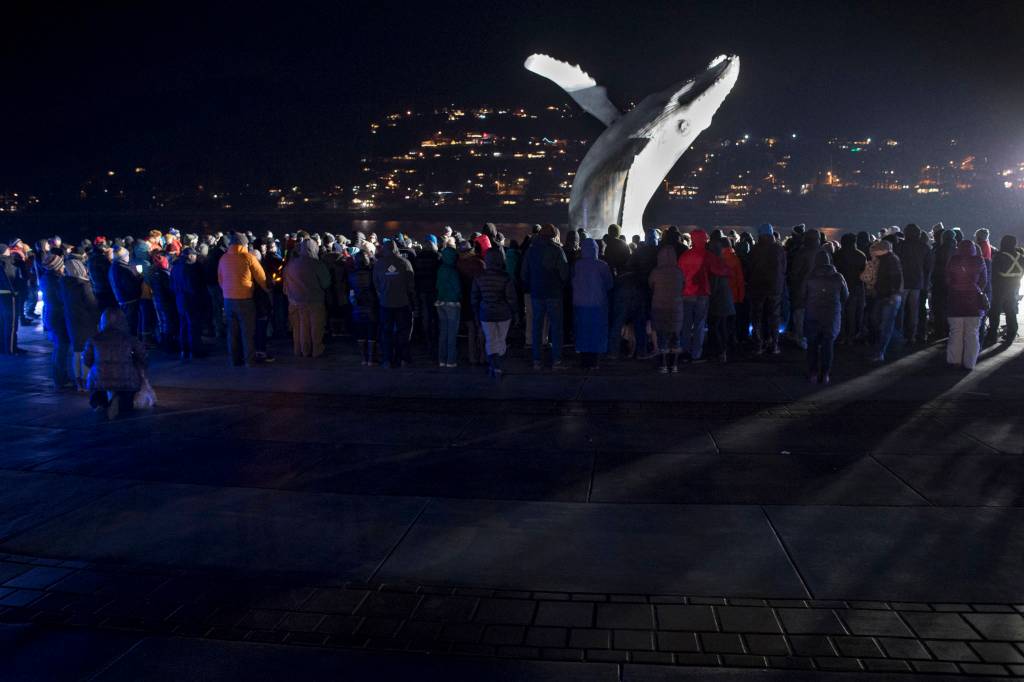 Hundreds of Juneau residents turnout Friday, Feb. 1, 2019, in 8-degree weather for a candlelight vigil at Mayor Bill Overstreet Park for the Guardian medical flight crew that went missing this week. (Michael Penn | Juneau Empire)