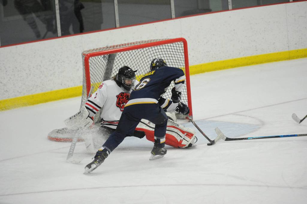 Homers Ethan Pitzman scores the Mariners second goal against Cody Mitchell. (Michael Dinneen | For the Juneau Empire)