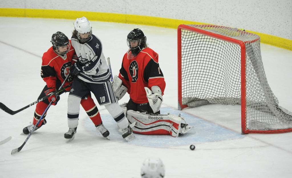 Juneau-Douglas Cody Mitchell makes a save against Soldotnas Braxton Urban as Cameron Smith helps out on defense in the Division II state hockey championships third-place game on Saturday, Feb. 2, 2019. (Michael Dinneen | For the Juneau Empire)