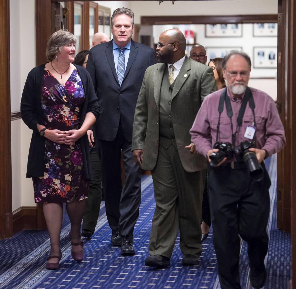 Gov. Mike Dunleavy is escorted to his State of the State speech in the House chamber at the Capitol in Juneau, Alaska, by Rep. Sara Hannan, D-Juneau, left, and Sen. David Wilson, R-Wasilla, (and Gavel Alaskas Skip Gray, right) to a Joint Session of the Alaska Legislature on Tuesday, Jan. 22, 2019. (Michael Penn | Juneau Empire)