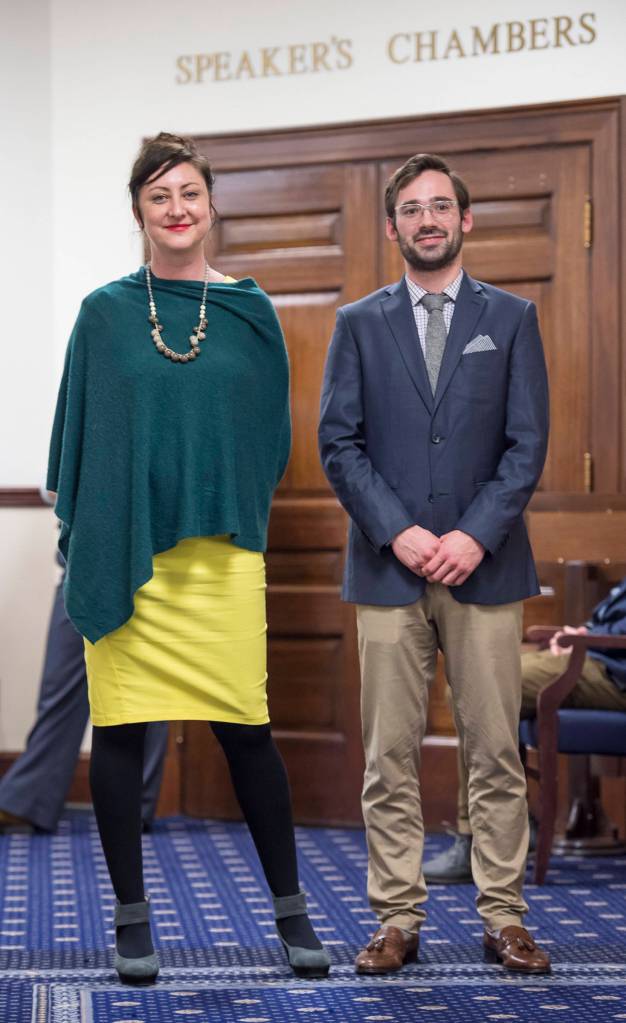 Amory Lelake, left, and Drew Cason, staffers for Rep. Bryce Edgmon, take in events leading up to the State of the State at the Capitol on Tuesday, Jan. 22, 2019. (Michael Penn | Juneau Empire)