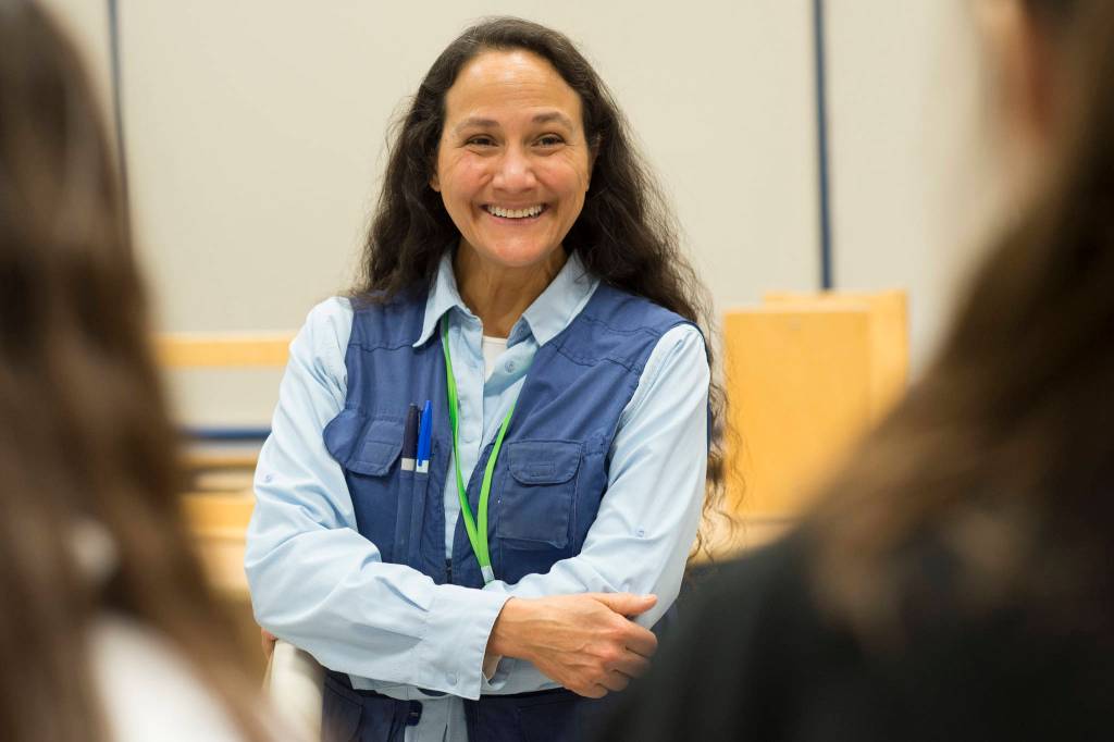 Thunder Mountain High School art teacher Angela Imboden talks to students on Wednesday, Jan. 30, 2019, who participated in a blind contour drawing project and received a signed drawing of a deers head on plexiglass by professional contour artist Ian Sklarsky. (Michael Penn | Juneau Empire)