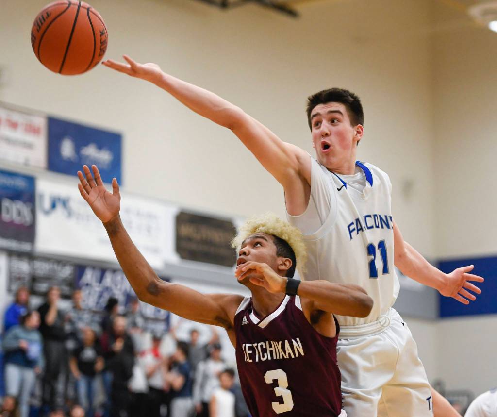 Thunder Mountains Braden Jenkins attempts to rebound over Ketchikans Marcus Lee at TMHS on Friday, Feb. 8, 2019. TMHS won 62-55. (Michael Penn | Juneau Empire)