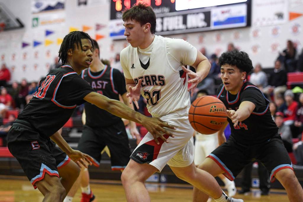 Juneau-Douglas Cooper Kriegmont is stripped of the ball by East Anchorages Jaron Williams, left, and Nicholas Chichenoff at JDHS on Friday, Feb. 8, 2019. East won 66-54. (Michael Penn | Juneau Empire)