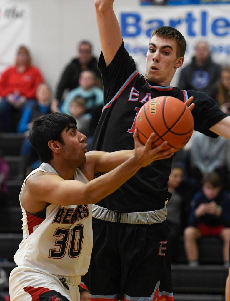 Juneau-Douglas Krishant Samtani attempts to score against East Anchorages Andrew Graves at JDHS on Friday, Feb. 8, 2019. East won 66-54. (Michael Penn | Juneau Empire)
