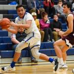 Thunder Mountains Meki Toutaoilepo chases down a loose ball against Ketchikans Robert Hilton Seludo at TMHS on Friday, Feb. 8, 2019. TMHS won 62-55. (Michael Penn | Juneau Empire)