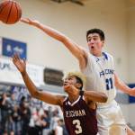 Thunder Mountains Braden Jenkins attempts to rebound over Ketchikans Marcus Lee at TMHS on Friday, Feb. 8, 2019. TMHS won 62-55. (Michael Penn | Juneau Empire)