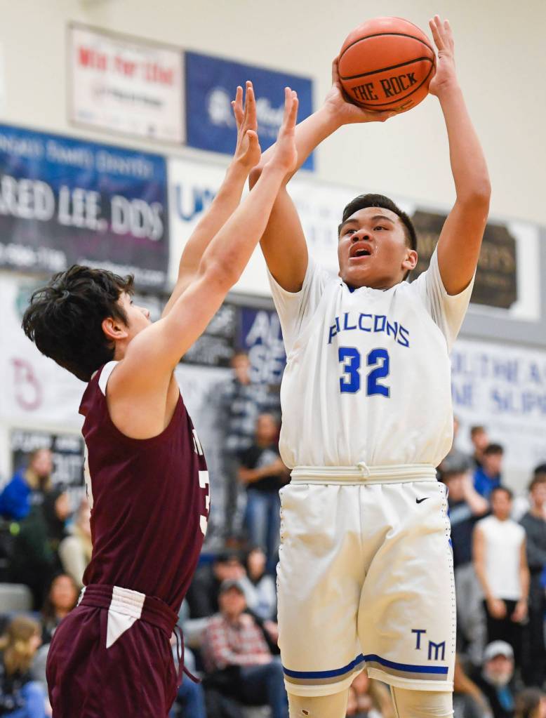 Thunder Mountains Meki Toutaoilepo shoots against Ketchikans James Nordlund at TMHS on Friday, Feb. 8, 2019. TMHS won 62-55. (Michael Penn | Juneau Empire)