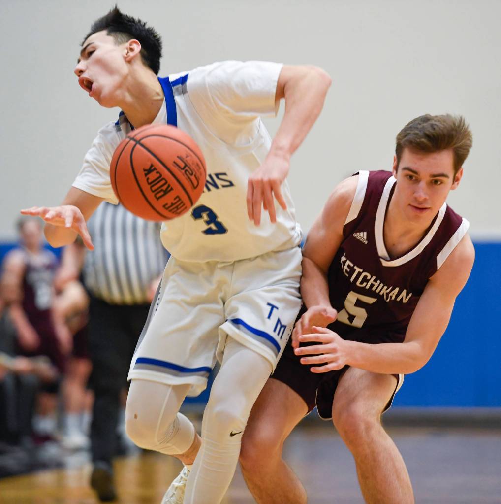 Thunder Mountains Bryson Echiverri, left, and Ketchikans Jake Taylor collide at TMHS on Friday, Feb. 8, 2019. TMHS won 62-55. (Michael Penn | Juneau Empire)