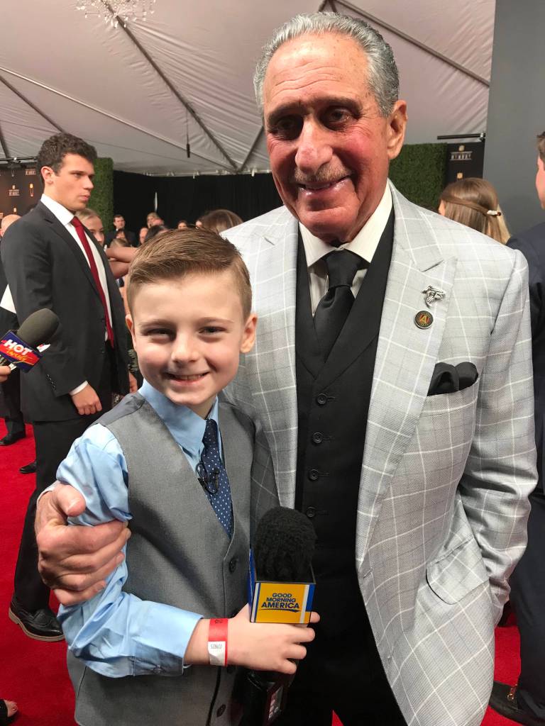 Atlanta Falcons owner Arthur Blank hugs Juneaus Camdyn Clancy on the Red Carpet during the NFL Honors at the FOX Theatre in Atlanta on Saturday, Feb. 2. The Juneau third-grader and Seattle Seahawks superfan won an all-expense paid trip to cover Super Bowl LIII as the grand prize winner of the NFL PLAY 60 Super Kid contest. (Courtesy Photo | Hannah Clancy)