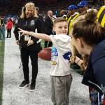 Camdyn Clancy, 8, prepares to deliver to the game ball to the Super Bowl LIII officiating crew at the Mercedes-Benz Stadium in Atlanta on Sunday, Feb. 3, 2019. The Juneau third-grader and Seattle Seahawks superfan won an all-expense paid trip to cover the big game as the grand prize winner of the NFL PLAY 60 Super Kid contest. (Courtesy Photo | Hannah Clancy)