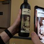 A phone app brings the label of a wine bottle to life at a wine and beer tasting and silent auction benefiting Juneau Animal Rescue at the Westmark Baranof Hotel, Saturday, Feb. 9, 2019. (Ben Hohenstatt | Capital City Weekly)