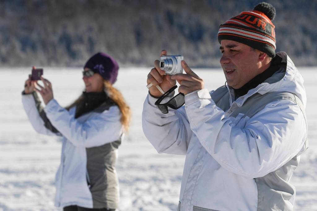 Robert Luna, right, and Stephanie Garren take a day off from their Coast Guard jobs to enjoy the Mendenhall Glacier on Monday, Feb. 11, 2019. (Michael Penn | Juneau Empire)