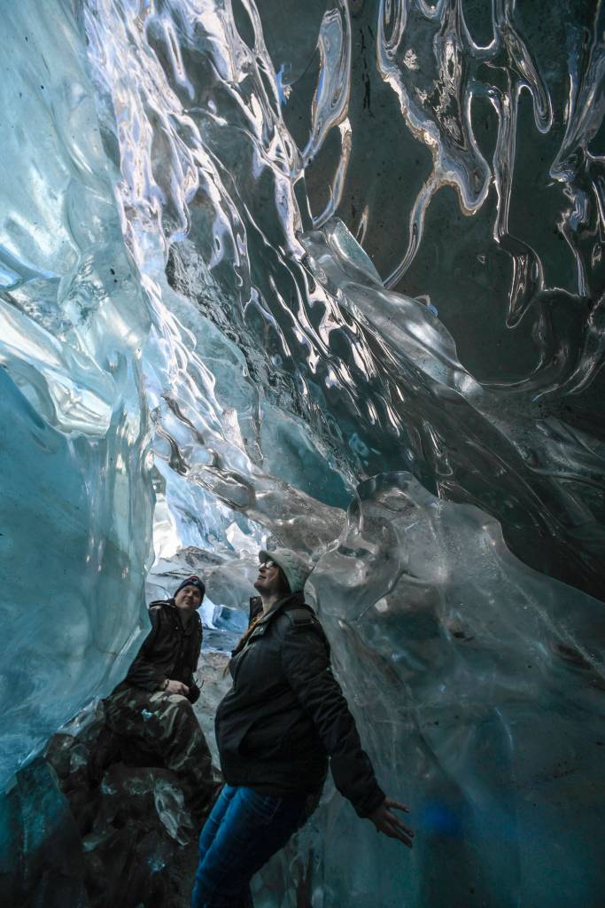 Helen Rice and her husband, Jason Writesel, visiting from Ohio, explore an ice cave at the Mendenhall Glacier on Monday, Feb. 11, 2019. (Michael Penn | Juneau Empire)