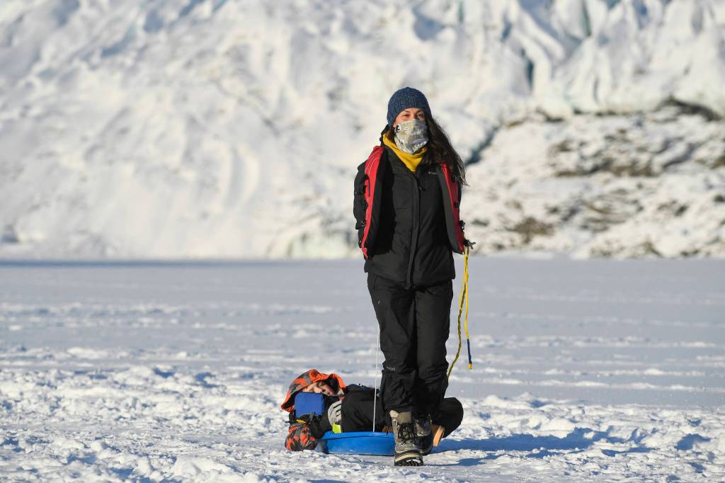 Alexia Keifer pulls her son, DJ, 8, after a day exploring at the Mendenhall Glacier on Monday, Feb. 11, 2019. (Michael Penn | Juneau Empire)