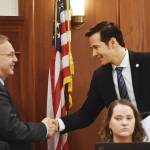 Speaker Pro Tempore Neal Foster, D-Nome, right, shakes hands with newly elected Speaker of the House Bryce Edgmon, D-Dillingham, in the House on Thursday, Feb. 14, 2019. (Michael Penn | Juneau Empire)