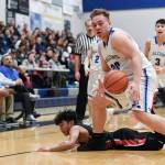 Thunder Mountains Vaipuna Toutaiolepo grabs a loose ball in front of Juneau-Douglas Israel Yadao at THMS on Friday, Feb. 15, 2019. TMHS won 69-59. (Michael Penn | Juneau Empire)