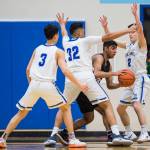 Thunder Mountains Bryson Echiverri, left, Meki Toutaoilepo, center, and Hansel Hinckle, right, pressure Juneau-Douglas Krishant Samtani at THMS on Friday, Feb. 15, 2019. TMHS won 69-59. (Michael Penn | Juneau Empire)