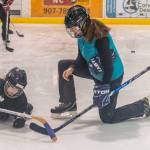 Coach Eliza Dorn works closely with a young girl during a recent practice at Treadwell Ice Arena. (Courtesy Photo | Steve Quinn)