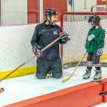 Coach Dan Fabrello shoots a quick smile at a JDIA youth player during a recent practice at Treadwell Ice Arena. (Courtesy Photo | Steve Quinn)