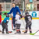 Coach Alec Venechuk shares a laugh with a group of players during a recent practice at Treadwell Ice Arena. (Courtesy Photo | Steve Quinn)