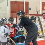 Heather Brandon helps a few players rehydrate during a recent practice at Treadwell Ice Arena. (Courtesy Photo | Steve Quinn)
