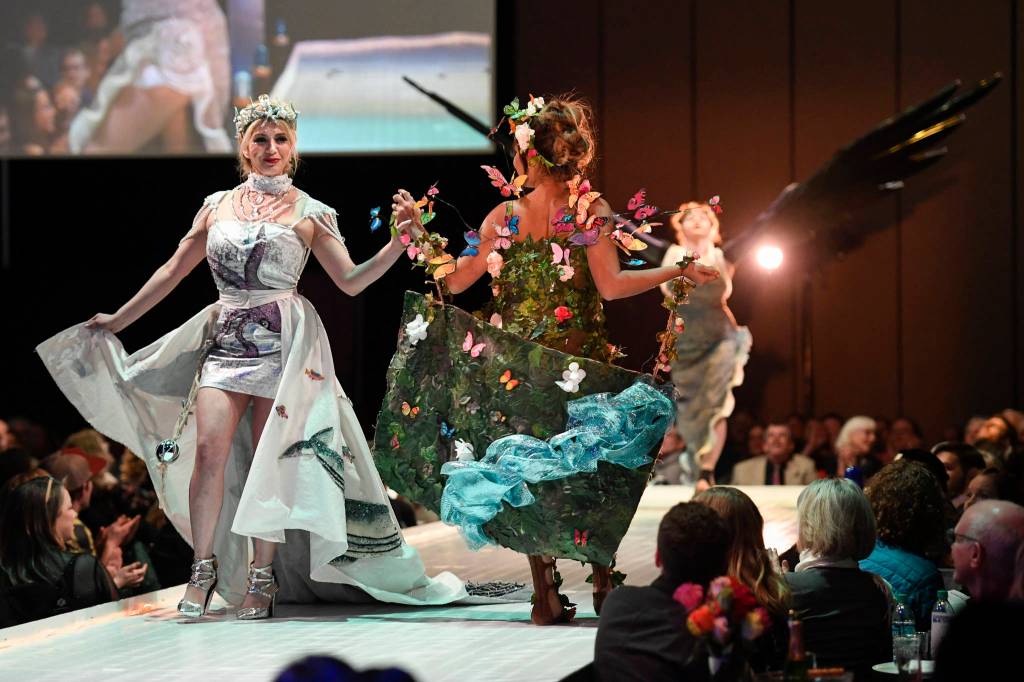 Maleny Villagomez, Samantha Harrison and Tesa Castillo work the runway with the piece Protect What is Sacred at the Wearable Art show at Centennial Hall on Saturday, Feb. 16, 2019. The artists are Paty Villagomez and Glo Ramirez. (Michael Penn | Capital City Weekly)
