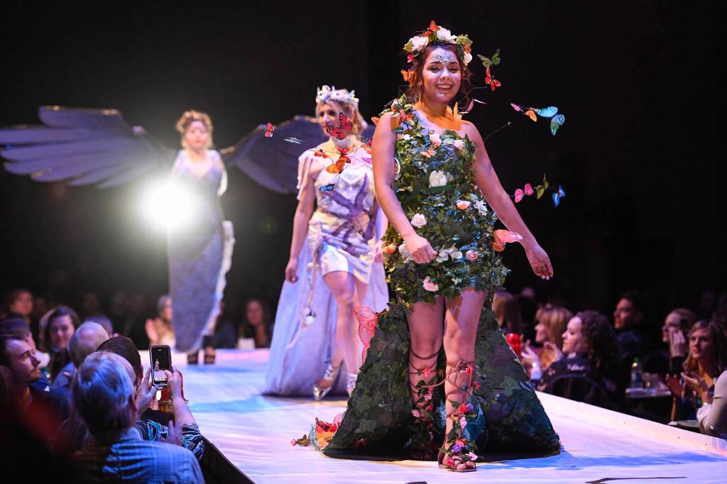 Maleny Villagomez, Samantha Harrison and Tesa Castillo work the runway with the piece Protect What is Sacred at the Wearable Art show at Centennial Hall on Saturday, Feb. 16, 2019. The artists are Paty Villagomez and Glo Ramirez. (Michael Penn | Capital City Weekly)