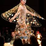 Artist Rhonda Jenkins Gardinier makes her way along the runway in her creation titled Wishes & Prayers in Turbulent Times of wire, wire hangers, tin can ends and fishing swivels at the Wearable Art show at Centennial Hall on Saturday, Feb. 16, 2019. (Michael Penn | Capital City Weekly)