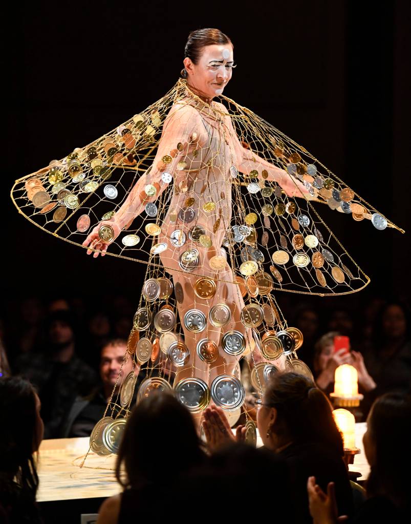 Artist Rhonda Jenkins Gardinier makes her way along the runway in her creation titled Wishes & Prayers in Turbulent Times of wire, wire hangers, tin can ends and fishing swivels at the Wearable Art show at Centennial Hall on Saturday, Feb. 16, 2019. (Michael Penn | Capital City Weekly)