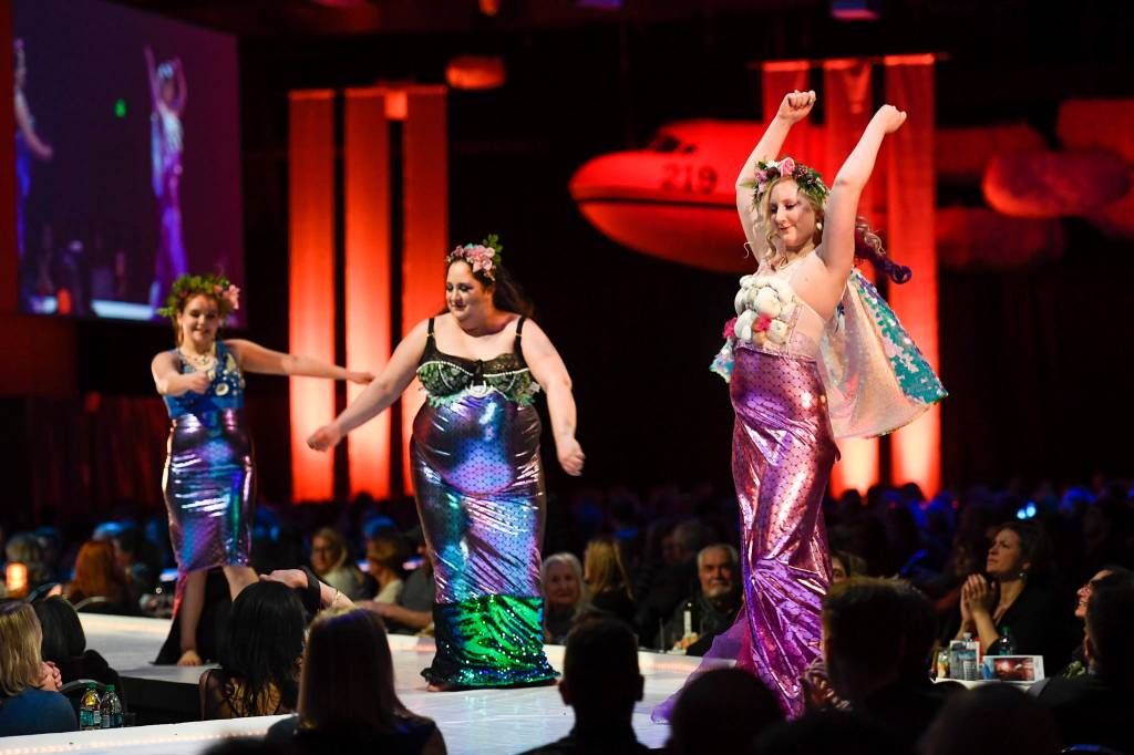 Artists Mandee Collins and Anna Orendorff get help modeling from Chloe Benc modeling their Sirens of the Sea at the Wearable Art show at Centennial Hall on Saturday, Feb. 16, 2019. (Michael Penn | Capital City Weekly)