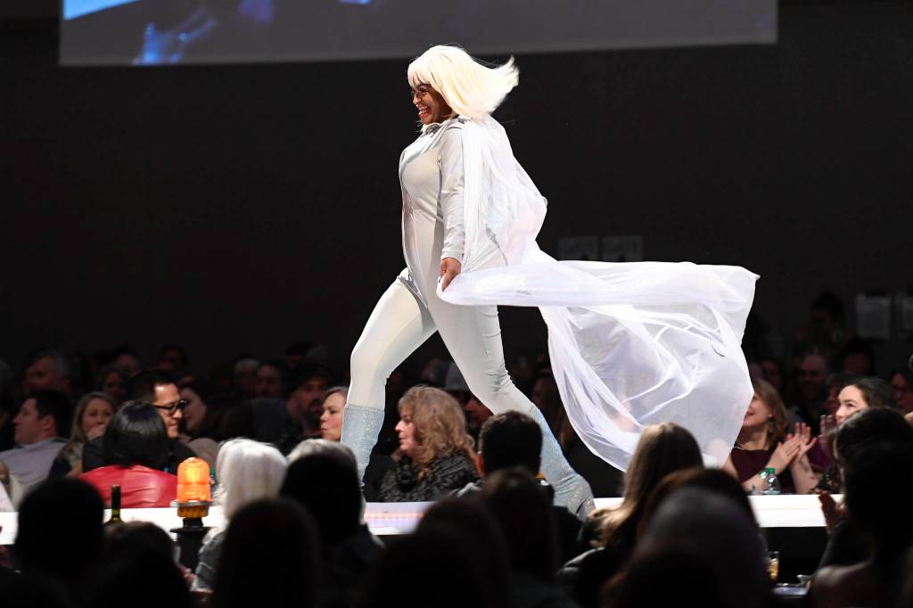 Co-Master of Ceremonies Ericka Lee takes flight at the Wearable Art show at Centennial Hall on Saturday, Feb. 16, 2019. (Michael Penn | Capital City Weekly)