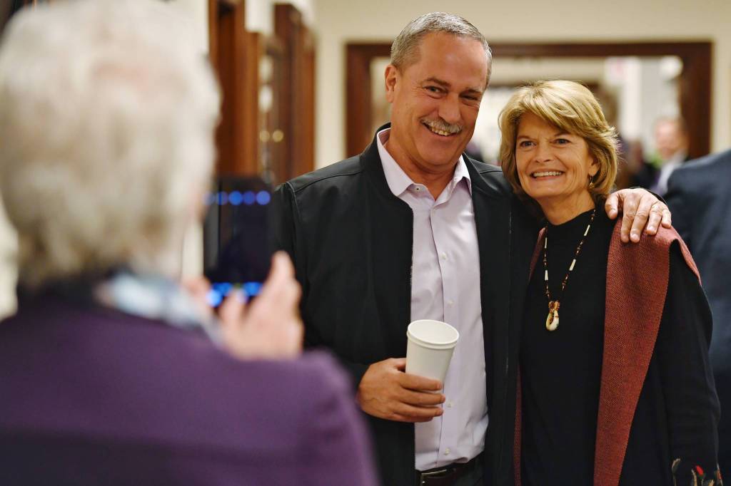 Former Representative and Senator Jerry Mackey, center, has his picture taken with U.S. Sen. Lisa Murkowski, R-Alaska, by Rep. Louise Stutes, R-Kodiak, as Murkowski arrives for her annual speech to a Joint Session of the Alaska Legislature on Tuesday, Feb. 18, 2019. (Michael Penn | Juneau Empire)