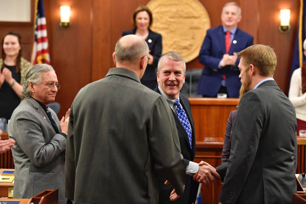 U.S. Sen. Dan Sullivan, R-Alaska, thanks Rep. Josh Revak, R-Anchorage, right, and Sen. Click Bishop, R-Fairbanks, for the escort into the House of Representatives for his annual speech to a Joint Session of the Alaska Legislature at the Capitol on Thursday, Feb. 21, 2019. (Michael Penn | Juneau Empire)