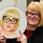 Melissa Griffiths with her self portrait at the Davis Gallery in Centennial Hall on Friday, Feb. 22, 2019. The Persisters are an all-female art collective, and their newest show Radical Self Love features dozens of self-portraits and opens for First Friday. (Michael Penn | Juneau Empire)