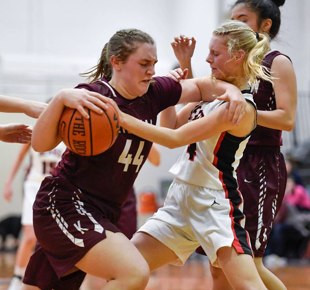 Ketchikans Dyllan Borer, left, pushes herself away from Juneau-Douglas Sadie Tuckwood at JDHS on Friday, Feb. 22, 2019. JDHS won 56-38. (Michael Penn | Juneau Empire)