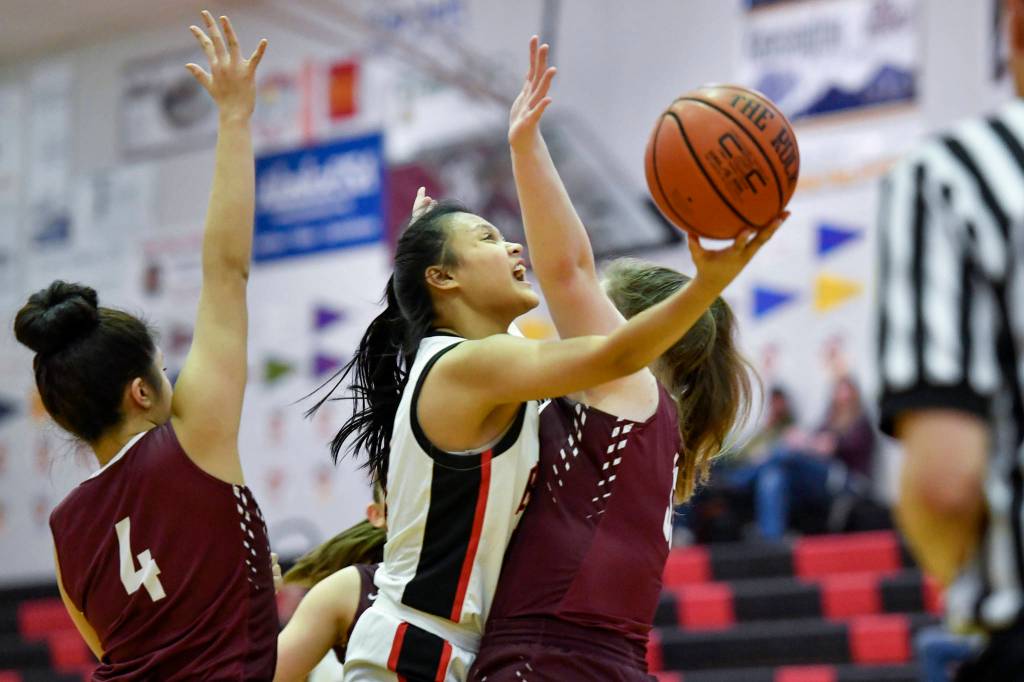 Juneau-Douglas Alyxn Bohulano lays the ball up against Ketchikan at JDHS on Friday, Feb. 22, 2019. JDHS won 56-38. (Michael Penn | Juneau Empire)