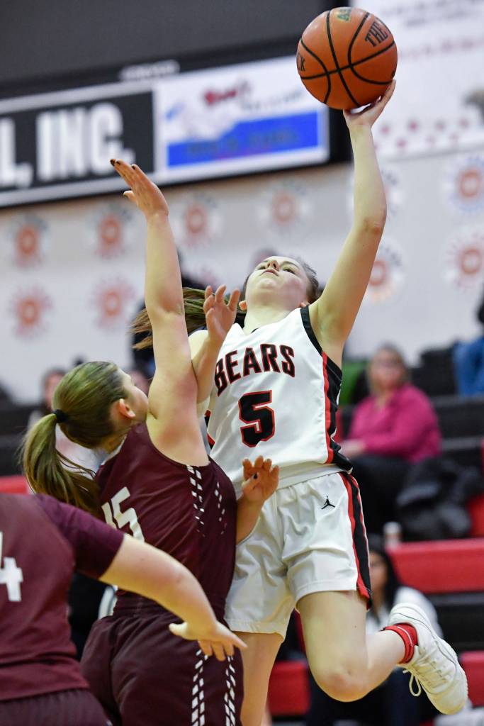 Juneau-Douglas Kiana Potter, right, shoots against Ketchikans Madison Rose at JDHS on Friday, Feb. 22, 2019. JDHS won 56-38. (Michael Penn | Juneau Empire)