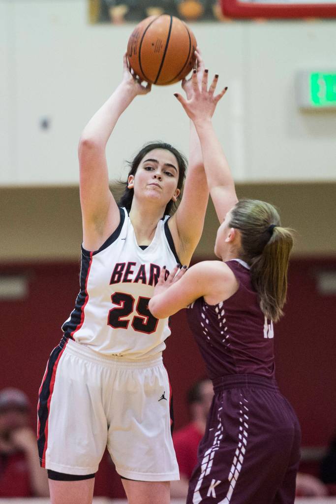 Juneau-Douglas Chloe McAdams passes over Ketchikans Madson Rose at JDHS on Friday, Feb. 22, 2019. JDHS won 56-38. (Michael Penn | Juneau Empire)