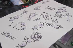 In this November 2018 file photo, suicide prevention-themed tattoos drawn by Salty Jack Reed Jr. wait for costumers during a special suicide prevention tattoo event. Suicide prevention is one of the causes helped by GCIs 2019 giving campaign. (Ben Hohenstatt | Juneau Empire File)