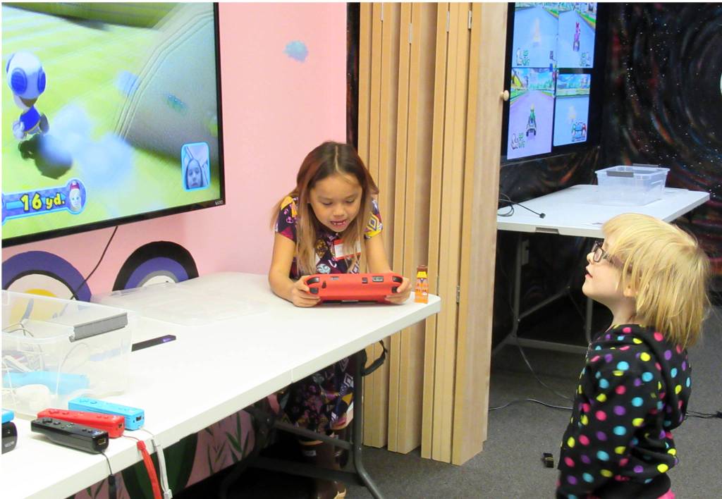 ChrisDee Scharen, 7, left, and Linden Harris, 4, right, play Wii U at Game Ons first Trans Gaming Night, Saturday, Feb. 23, 2019. (Ben Hohenstatt | Capital City Weekly)