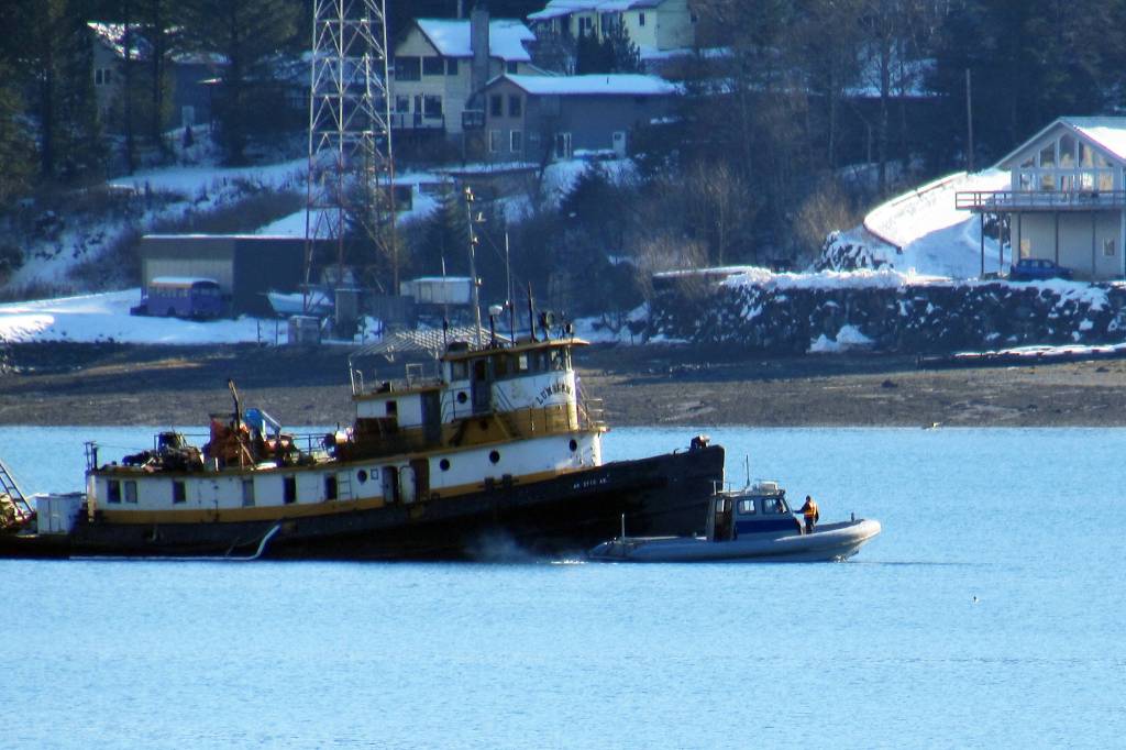 Global Diving was contracted to pump water from snow and rain from the derelict tug, the Lumberman, in Gastineau Channel on Tuesday, Feb. 26, 2019. (Ben Hohenstatt | Juneau Empire)