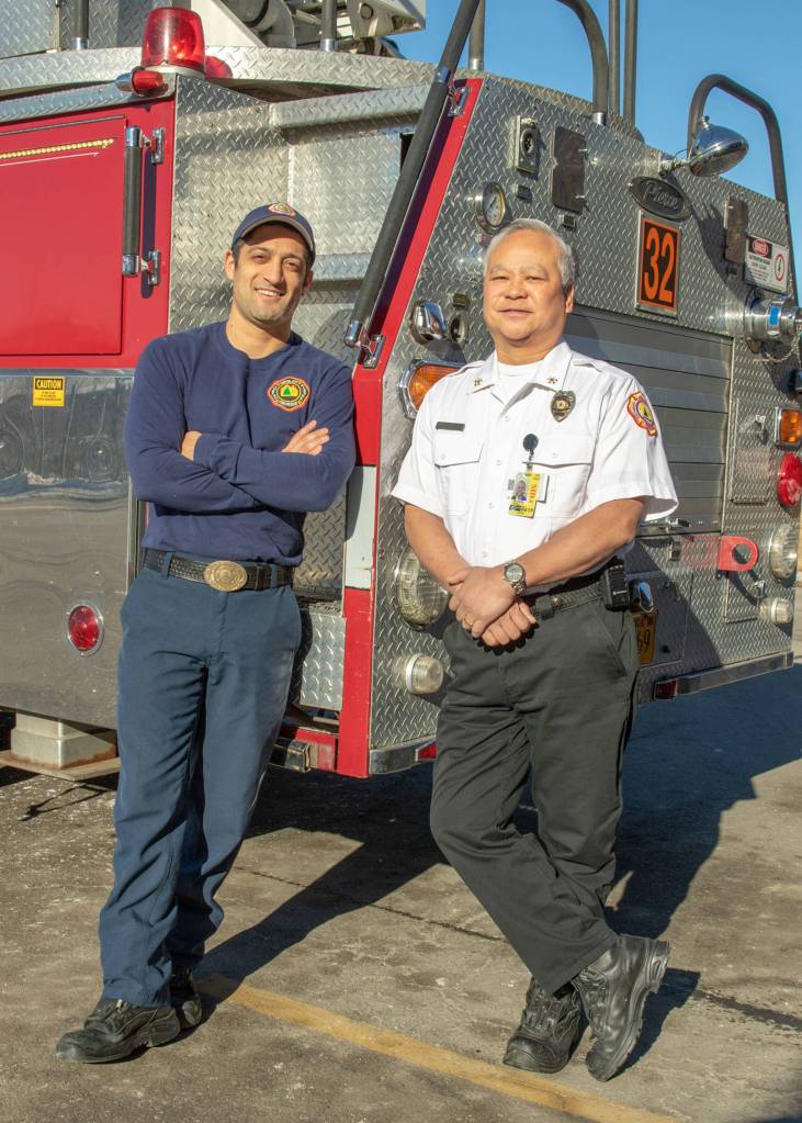 March 24, 2019: Theres just something about a guy in a uniform, and Cheyenne Sanchez and Ed Quinto both wear theirs well. Cheyenne is sporting a Capital City Fire and Rescues Class C or normal daily duty uniform  a navy T-shirt and navy pants. Ed is wearing the Class B uniform  a white shirt with his Assistant Fire Chief Badge and black pants. A white shirt signifies a chief officer or fire marshal. Zippered boots are a must so they can quickly get into gear to respond to a call. Thanks for your service guys  you both look great!