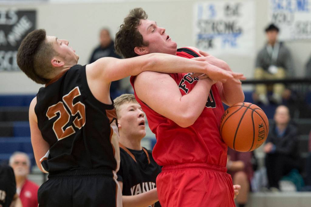 Yakutats Elijah Mash, left, fouls Gustavuss David Blaine at the Region V 1A Basketball Championships at Thunder Mountain High School on Wednesday, Feb. 27, 2019. Gustavus won 40-39. (Michael Penn | Juneau Empire)
