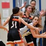 Skagways Tatum Sager is pressured by Yakutats Giuliana Hoadley, left, and Annie Harry at the Region V 1A Basketball Championships at Thunder Mountain High School on Wednesday, Feb. 27, 2019. (Michael Penn | Juneau Empire)