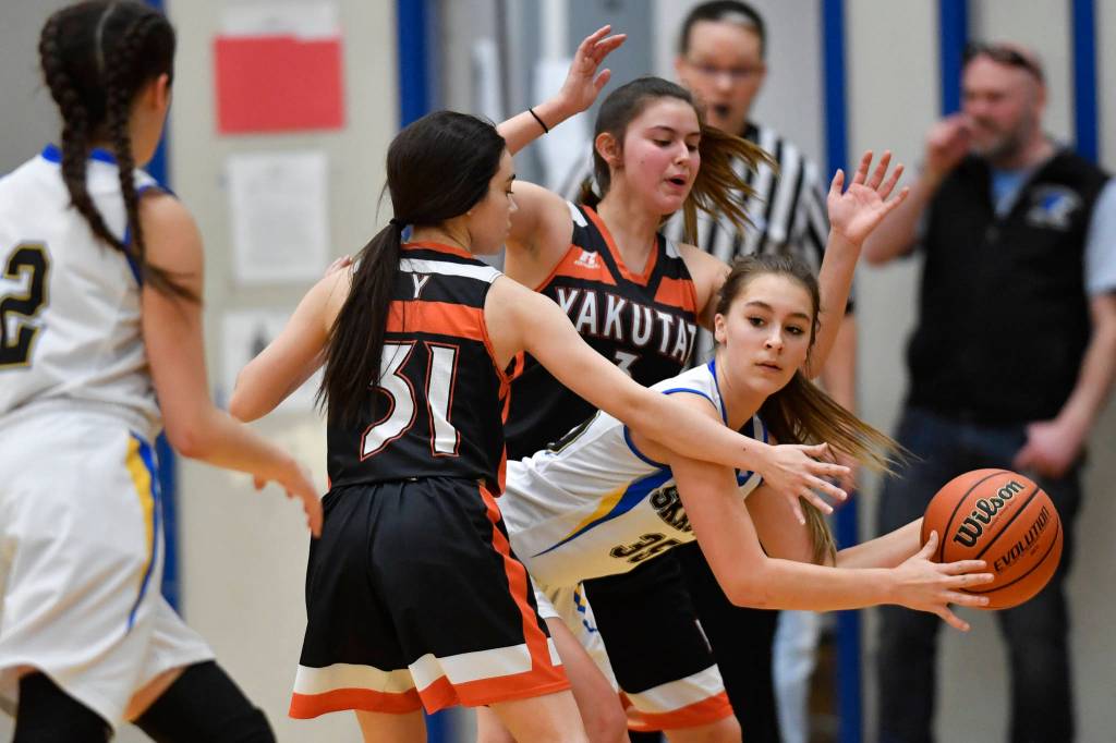Skagways Tatum Sager is pressured by Yakutats Giuliana Hoadley, left, and Annie Harry at the Region V 1A Basketball Championships at Thunder Mountain High School on Wednesday, Feb. 27, 2019. (Michael Penn | Juneau Empire)