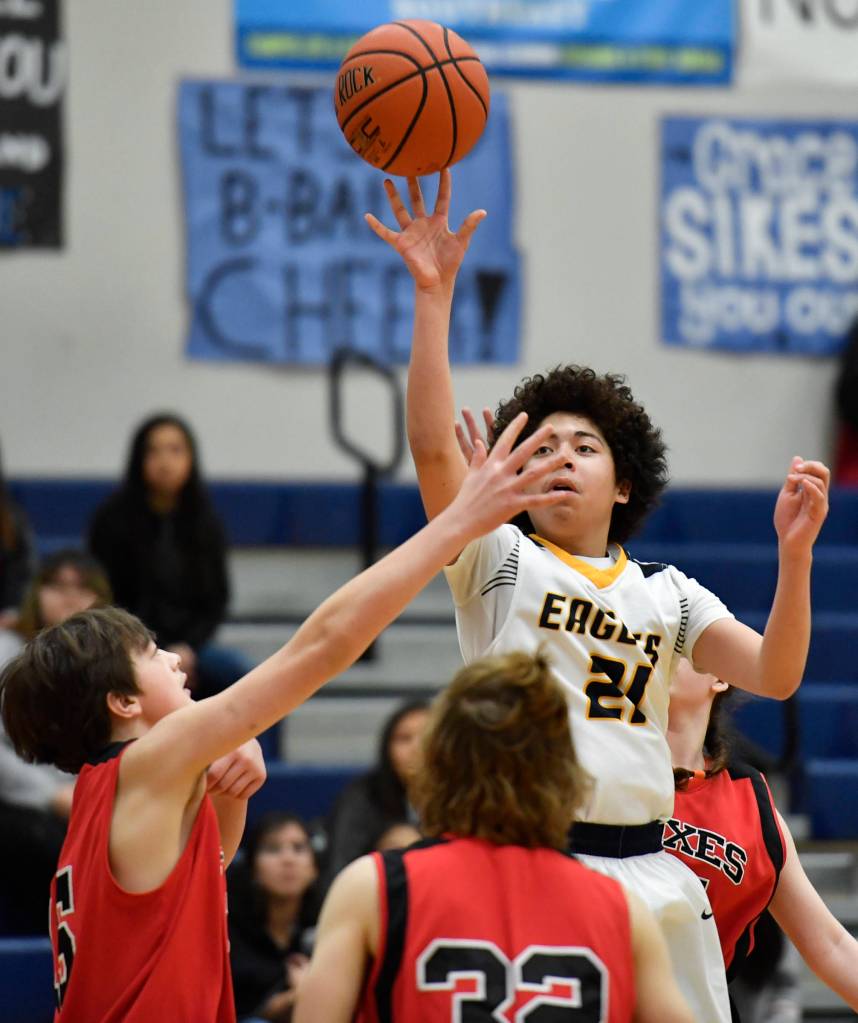Angoons Duncan Julian shoots over Gustavus Syllar Zink, left, at the Region V 1A Basketball Championships at Thunder Mountain High School on Thursday, Feb. 28, 2019. Angoon won 42-39. (Michael Penn | Juneau Empire)
