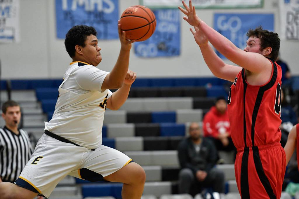 Angoons Anthony Johnson passes against Gustavus David Blaine at the Region V 1A Basketball Championships at Thunder Mountain High School on Thursday, Feb. 28, 2019. Angoon won 42-39. (Michael Penn | Juneau Empire)