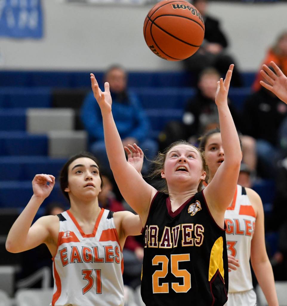 Hoonahs Sierra McClement rebounds the ball in front of Yakutats Giuliana Hoadley, left, and Annie Harry at the Region V 1A Basketball Championships at Thunder Mountain High School on Thursday, Feb. 28, 2019. Hoonah won 33-16. (Michael Penn | Juneau Empire)