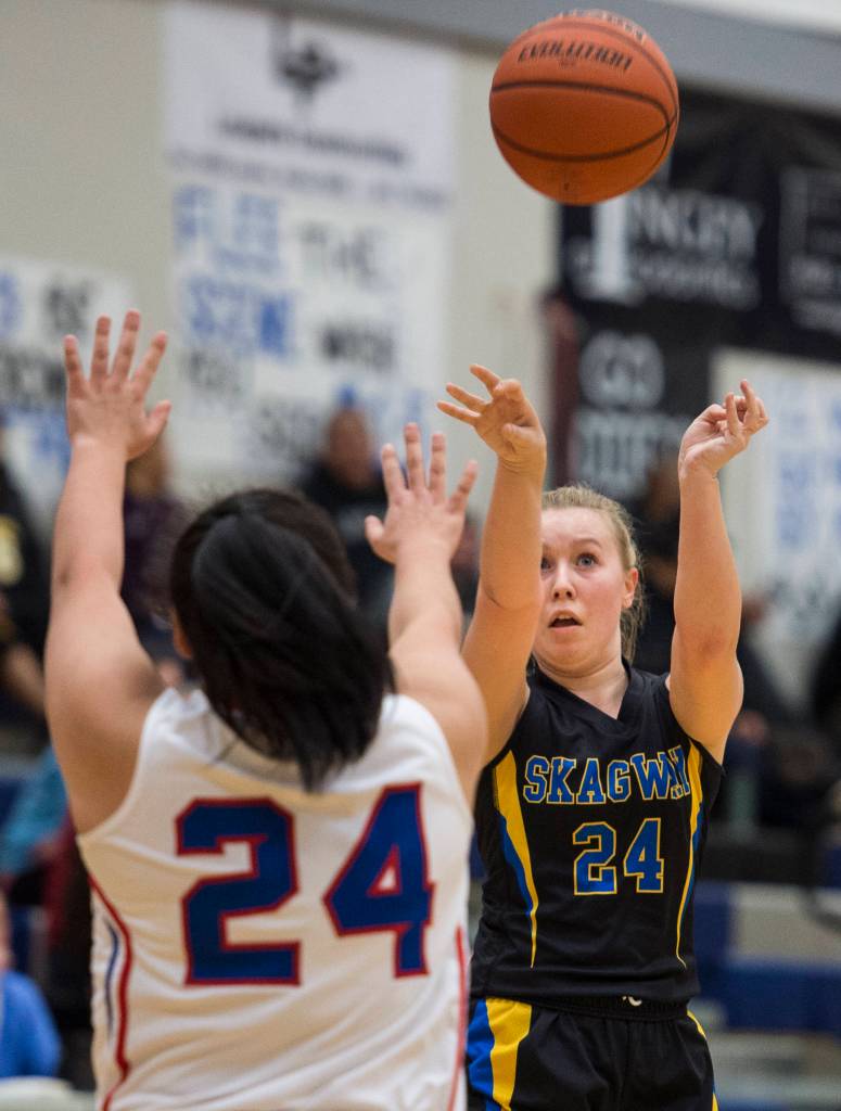 Skagways Madison Cox shoots over Kakes Felicia Ross-Shaquanie at the Region V 1A Basketball Championships at Thunder Mountain High School on Thursday, Feb. 28, 2019. Kake won 43-30. (Michael Penn | Juneau Empire)